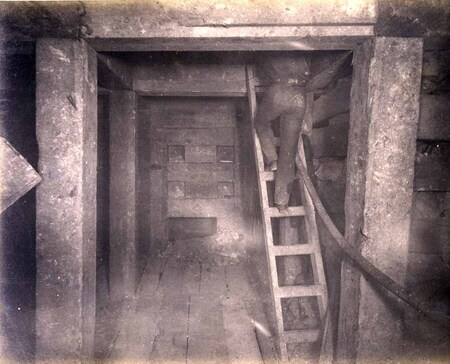 High ore 400 ft. level West Showing bulkheading in 1st floor and miner ascending to 2nd floor with hose for drilling machine